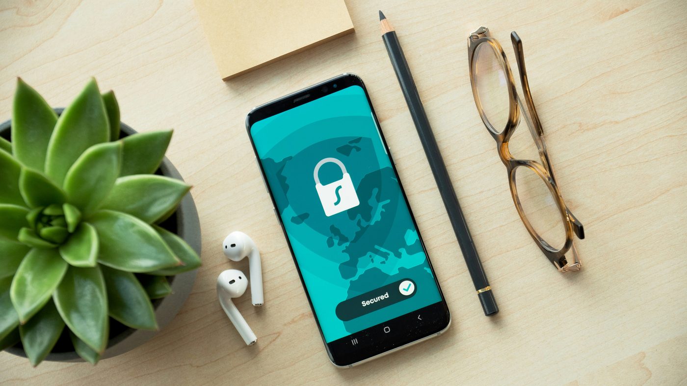 Phone showing a secured lock screen on a tidy desk